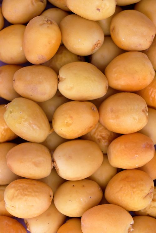 Free A close-up of ripe dates, showcasing their vibrant colors and smooth texture. Stock Photo