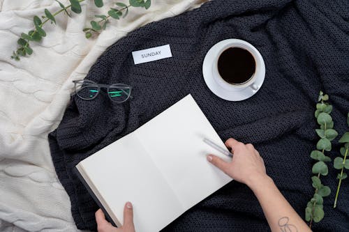 Free Person Holding White Paper Near Black Framed Eyeglasses Stock Photo