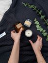 Person Holding Green Plant on White Textile