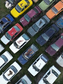 Aerial shot of colorful abandoned cars in a Turkish junkyard.