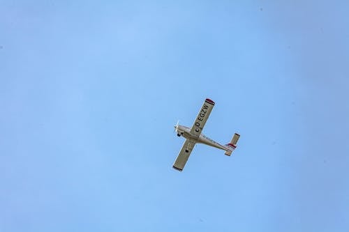 Free White and Red Airplane in Mid Air Stock Photo