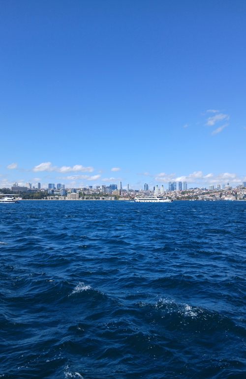 Free Stunning ocean view with a vibrant city skyline under a clear blue sky. Stock Photo