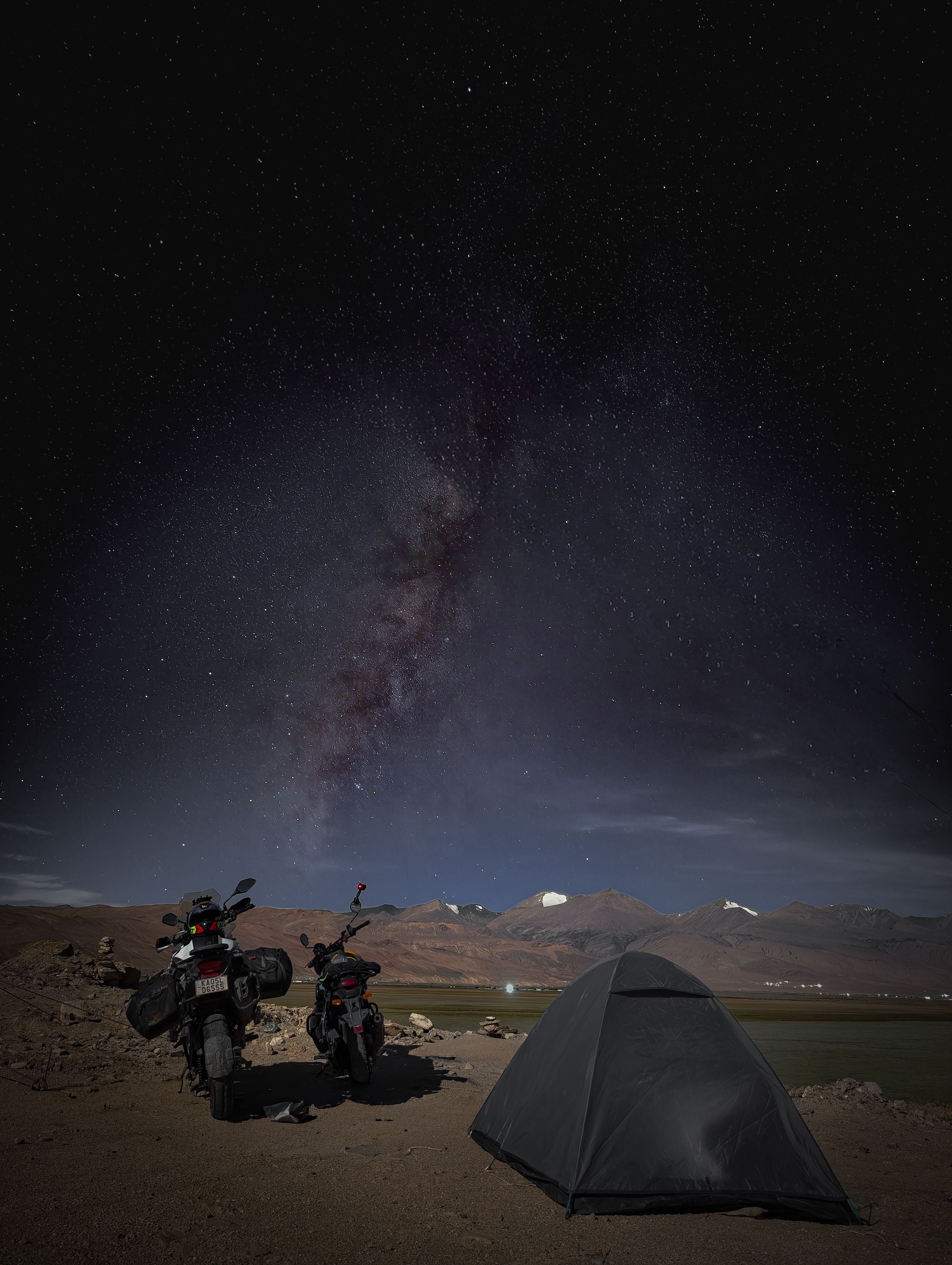 Camping under a starry sky with motorcycles in Marango Rangarik, Himachal Pradesh, India.
