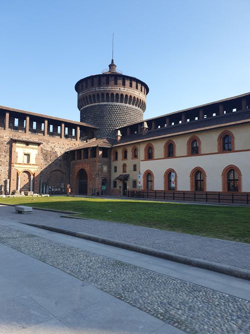 Free A view of the iconic Sforza Castle courtyard in Milan, showcasing its medieval architecture. Stock Photo