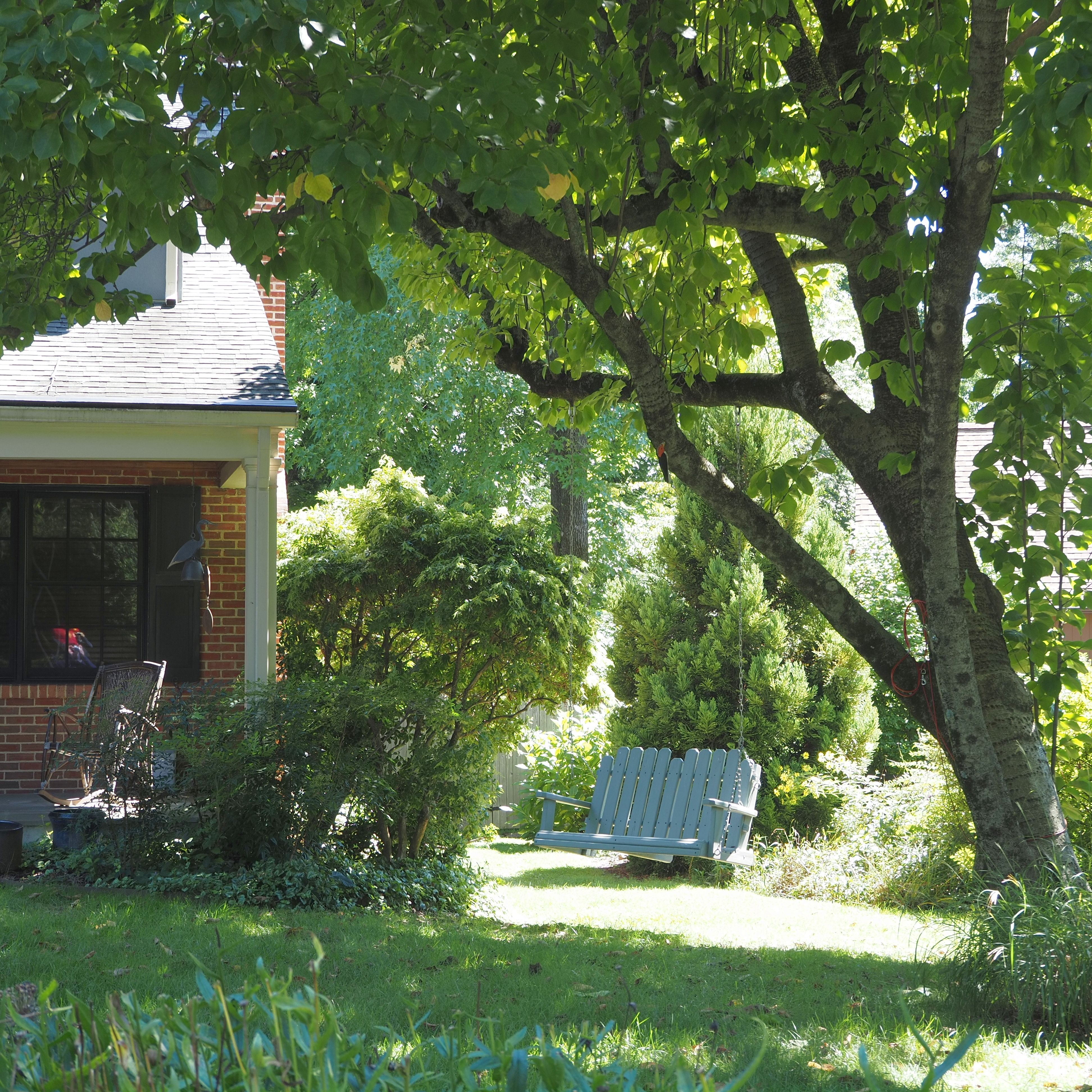 Peaceful backyard garden with classic architecture and lush greenery in Doylestown, Pennsylvania.
