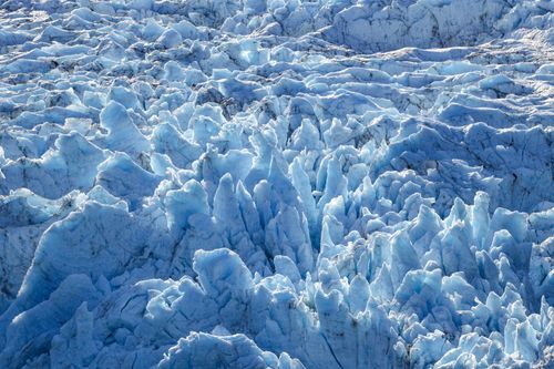 Free Breathtaking aerial shot capturing the intricate patterns of a glacier in Alaska. Stock Photo