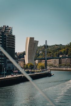 Scenic view of modern architecture along the Nervión River in Bilbao, Spain.