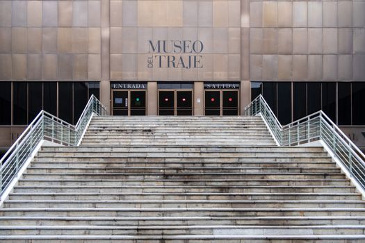 Staircase leading to Museo del Traje entrance in Madrid, featuring modern architecture.