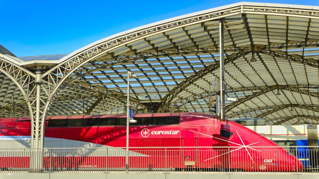 Eurostar train at a modern station with an architectural arch roof.