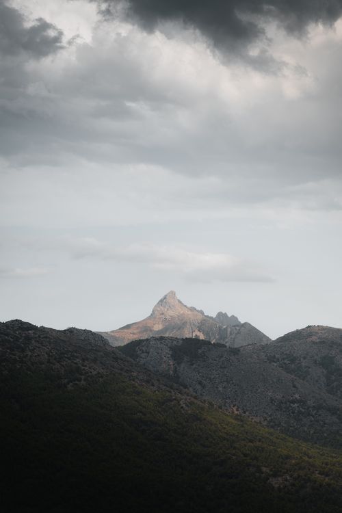 Free Majestic view of Monte Ponoig near El Castell de Guadalest, Spain under a dramatic sky. Stock Photo