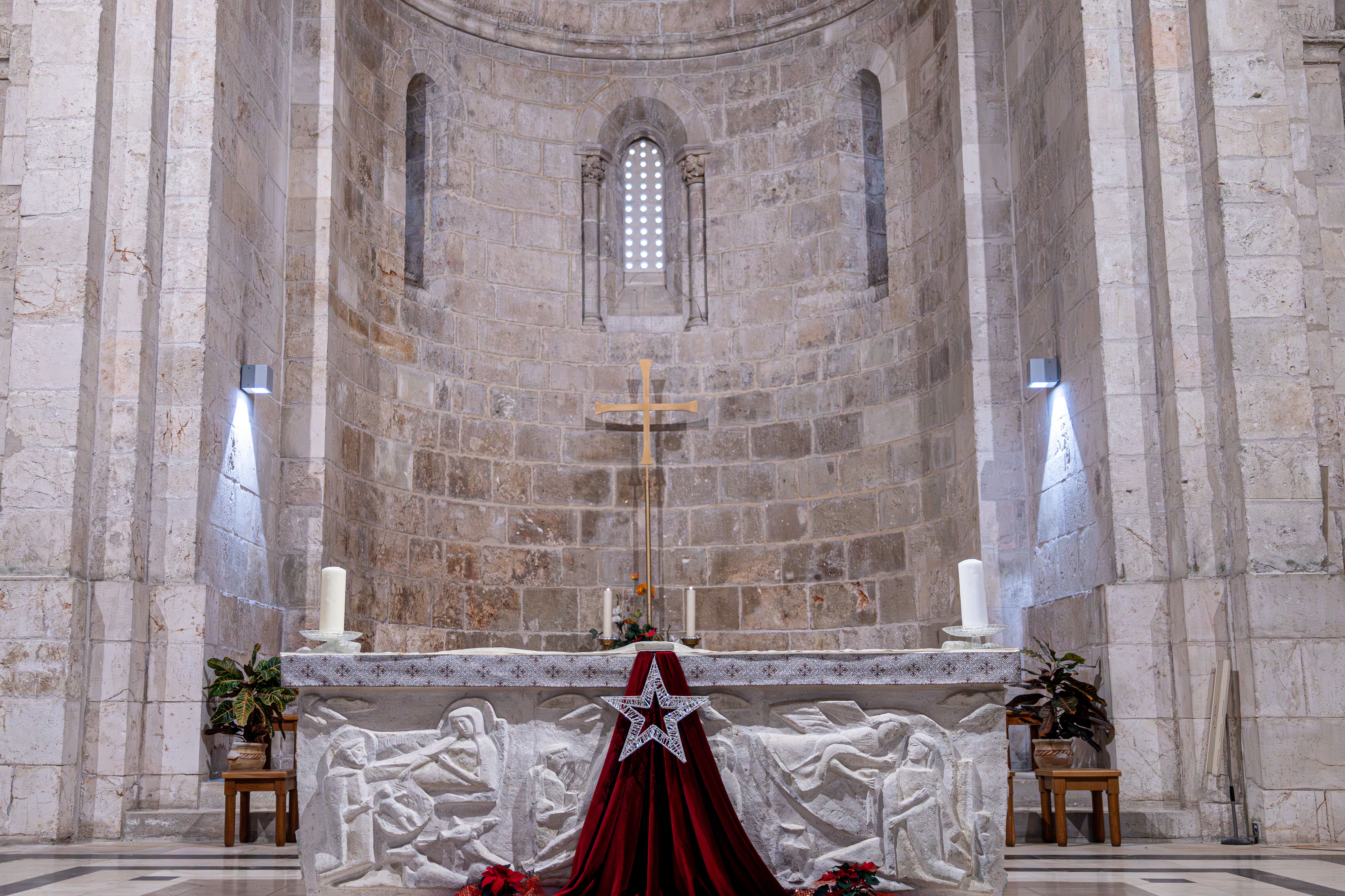 Beautiful church altar in Jerusalem with intricate carvings and a star decoration, capturing religious solemnity.