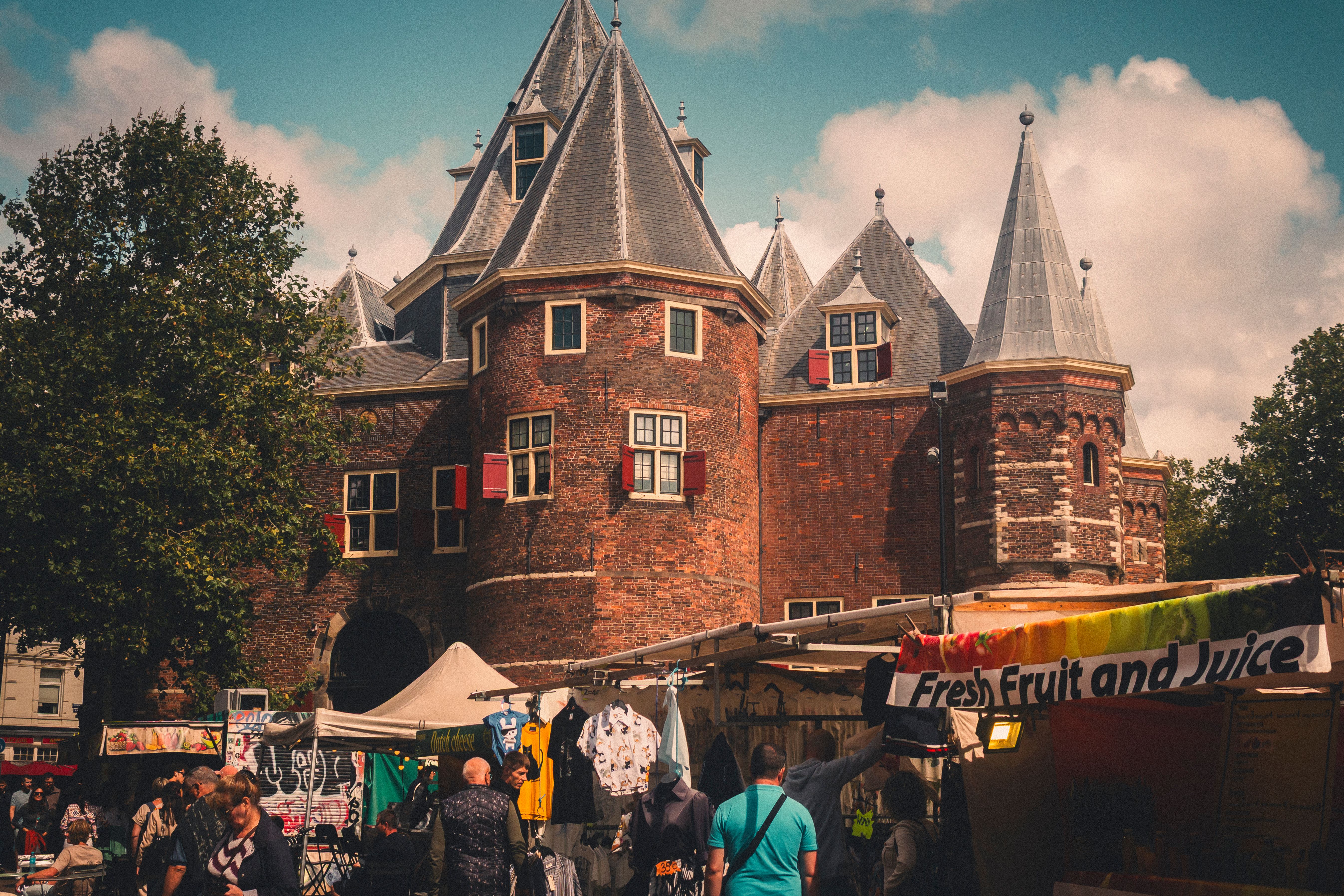 Explore the vibrant street market in Amsterdam with historic architecture as a backdrop.