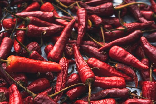 Free A vivid display of fresh red chili peppers, showcasing texture and color. Stock Photo