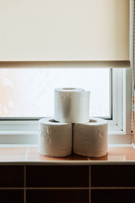 Three rolls of soft bath tissue stacked on a windowsill — photo by Lisa from Pexels
