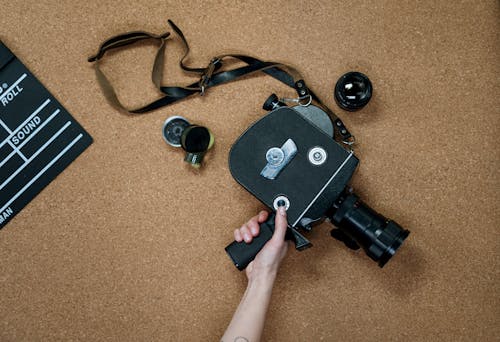 Black and Gray Camera on Brown Carpet