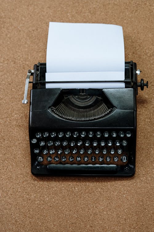 Black and White Typewriter on Brown Carpet