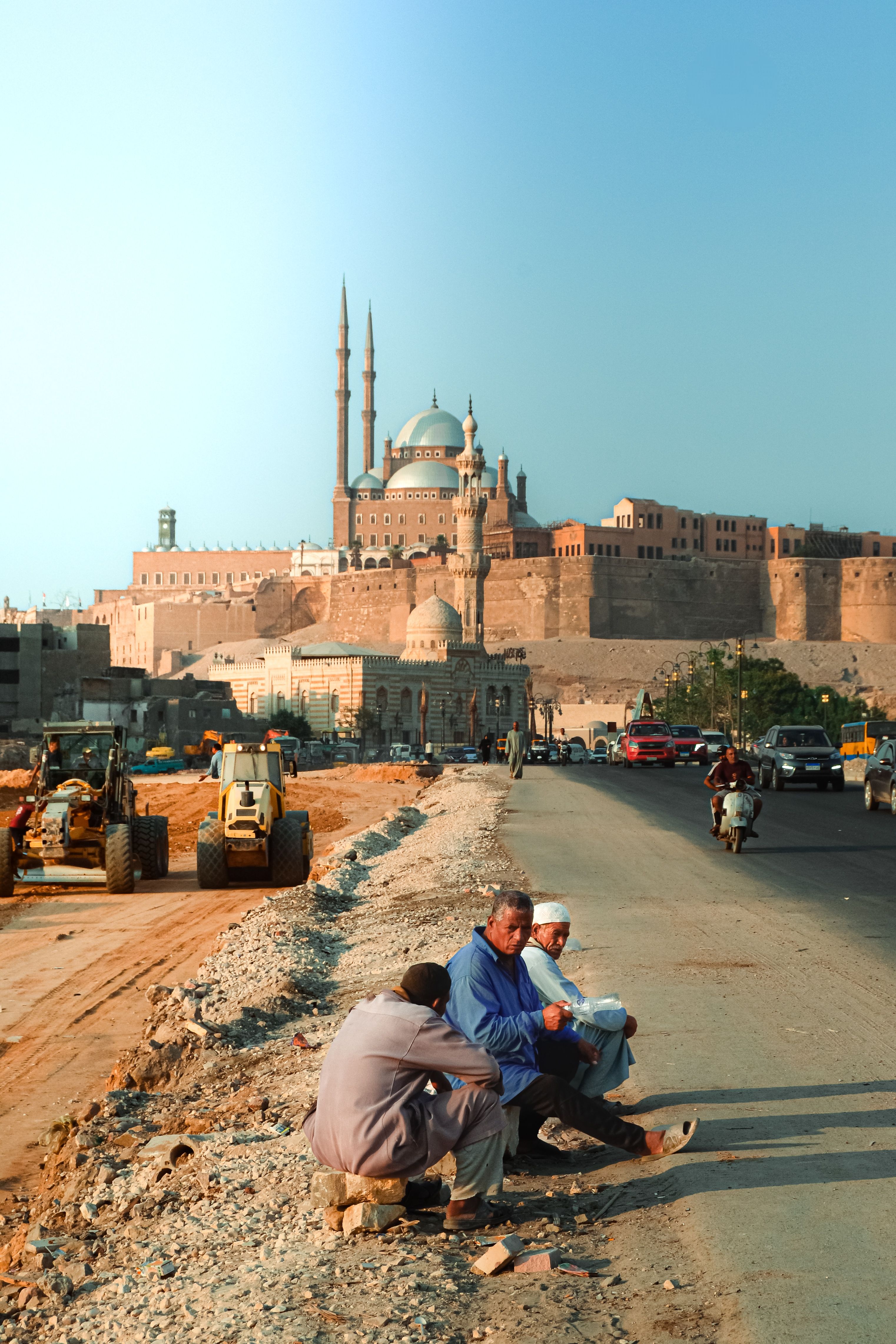 People resting by the road near the historic Mosque of Muhammad Ali in Cairo, Egypt.
