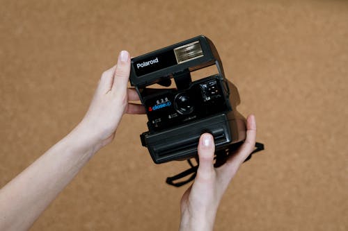 Free Person Holding Black Polaroid Camera Stock Photo