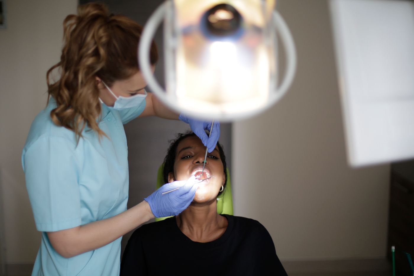 Black patient receiving attentive dental care