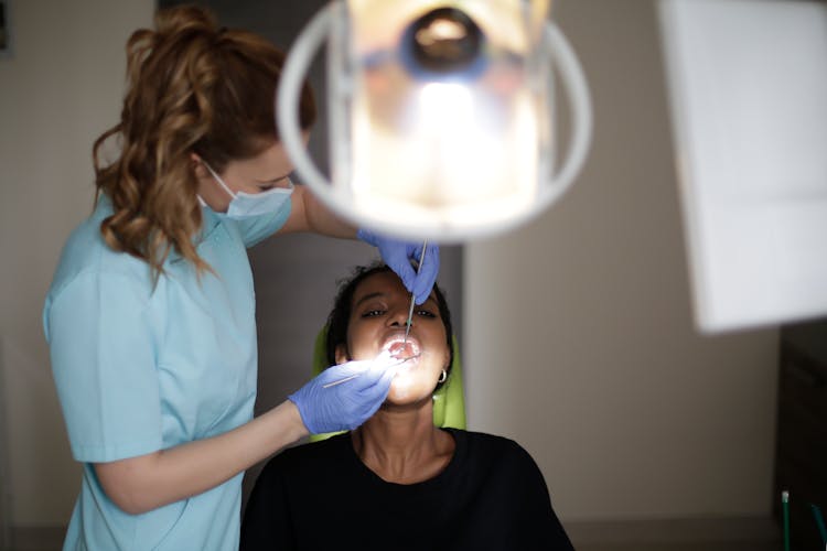 Dentist Curing Teeth Of Black Patient
