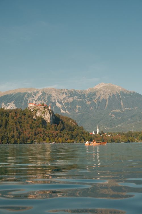 Free Picturesque Lake Bled featuring Bled Castle and majestic mountains. Stock Photo