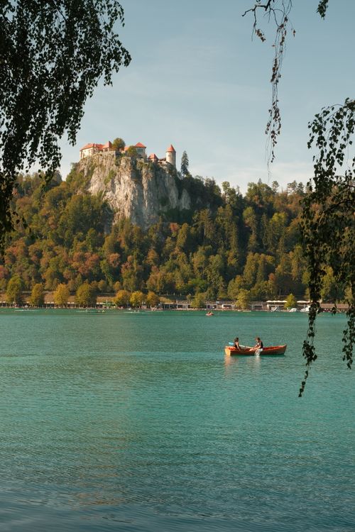 Free Tranquil canoeing scene at Lake Bled with majestic castle view. Stock Photo