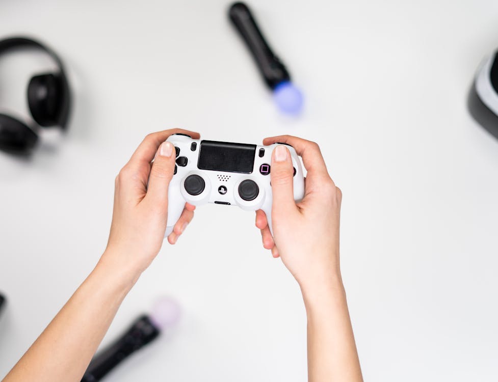 Free Person Holding White and Black Camera Stock Photo