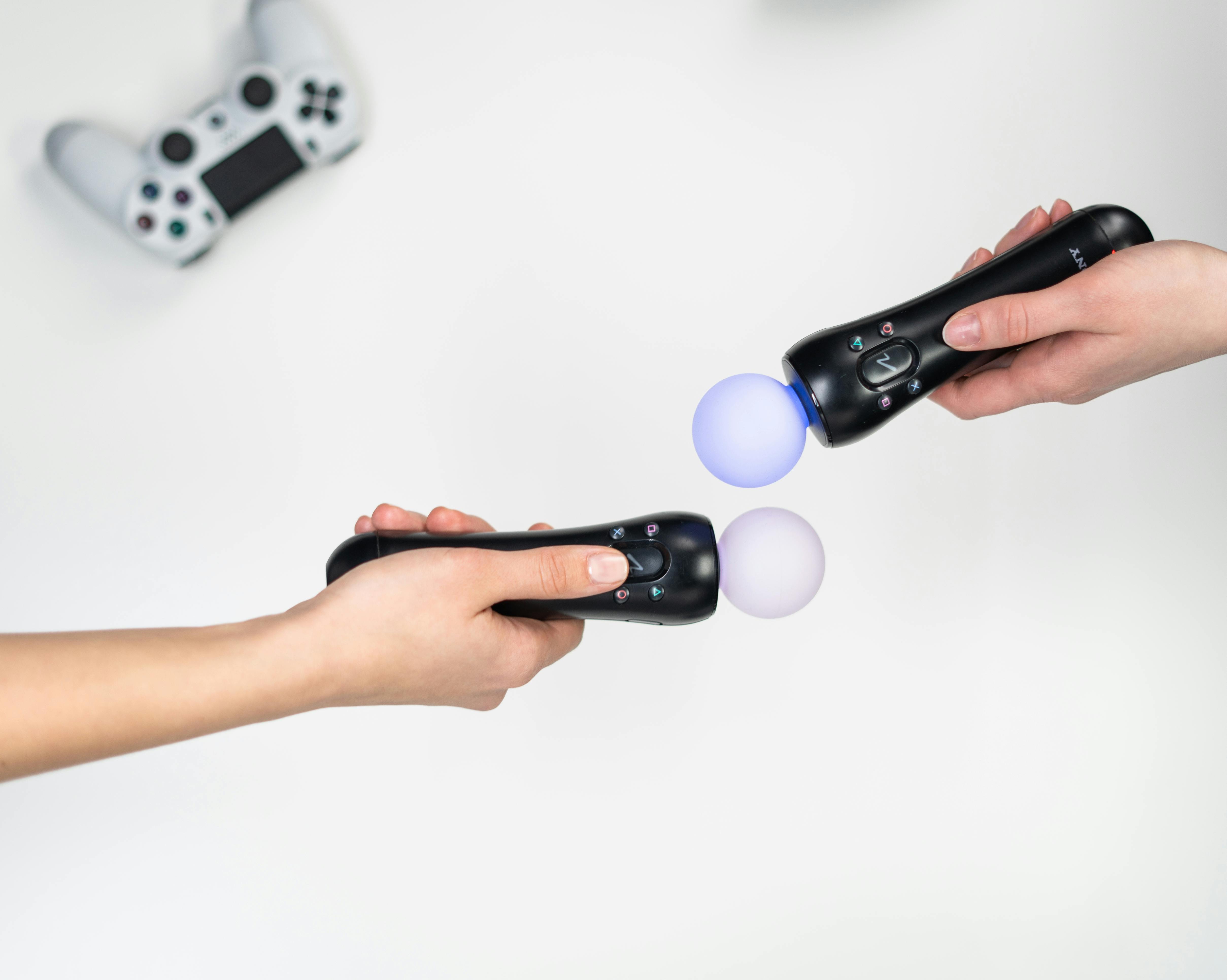 person holding black and white game controller