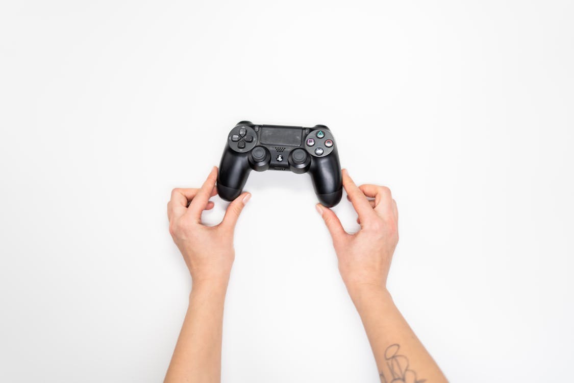 Person Holding Black Sony Ps 4 Game Controller
