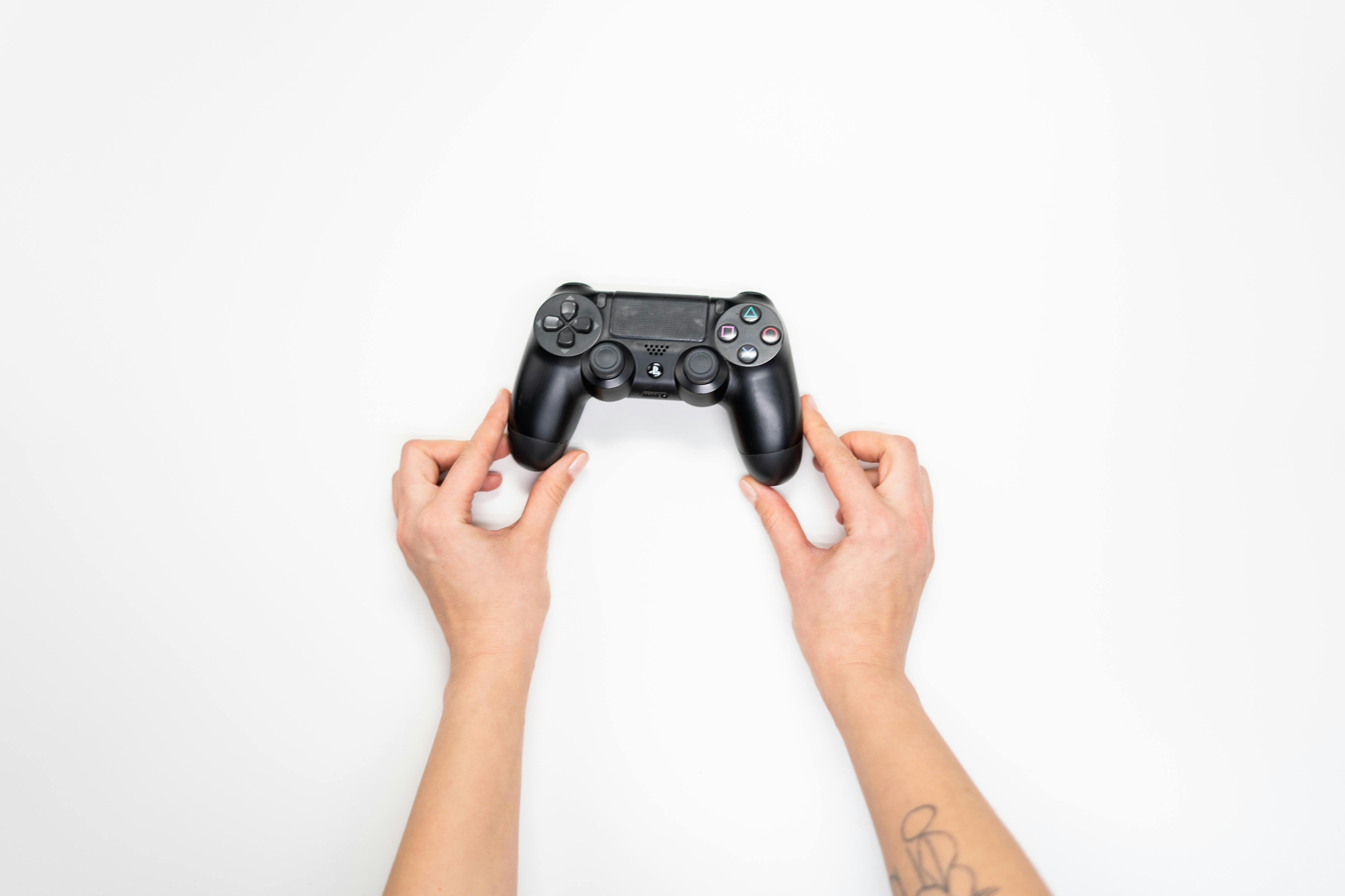 Person Holding Black Sony Ps 4 Game Controller · Free Stock Photo
