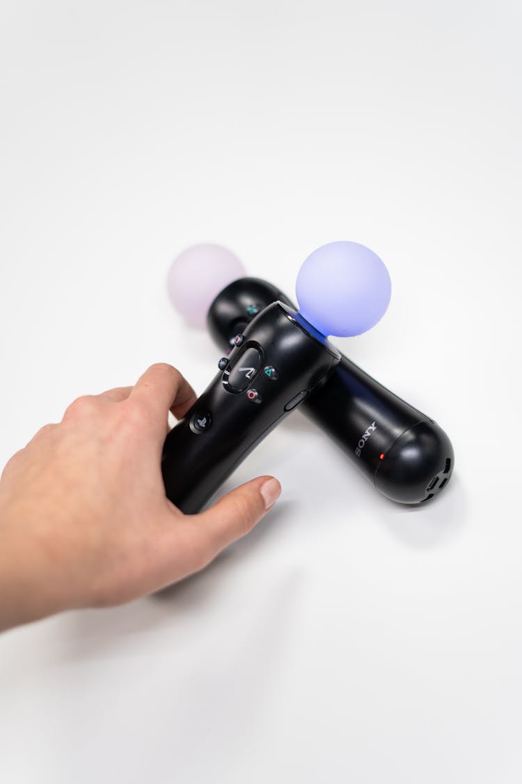 Person Holding Black Sony Ps 4 Game Controller