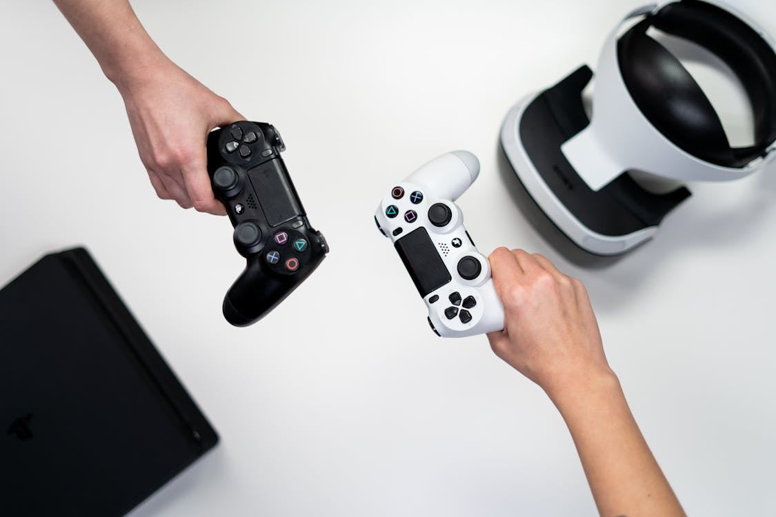 Person Holding White and Black Xbox One Game Controller