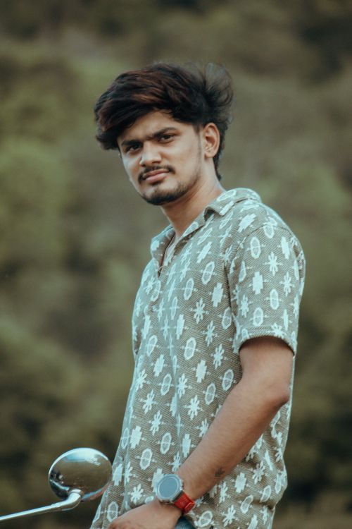Free A confident young man poses outdoors in Salem, Tamil Nadu. Captivating and serene setting. Stock Photo
