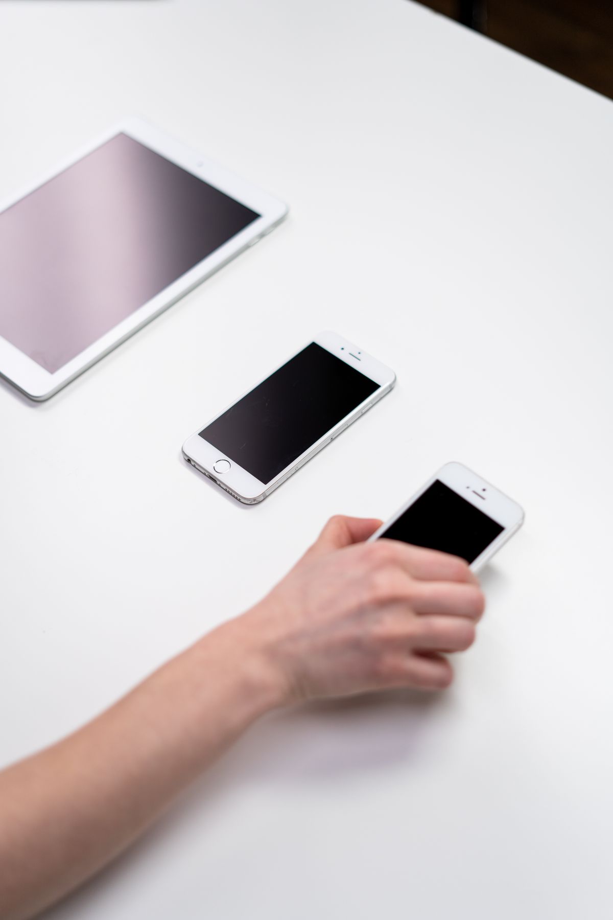 iPad and iPhone on a white surface