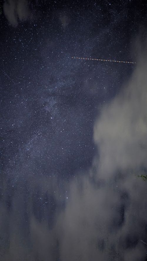 Free A vivid night sky full of stars and clouds over Anterivo, Trentino-Alto Adige, Italy. Stock Photo