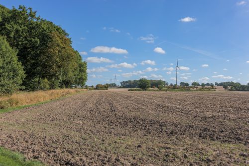 Free Serene rural scene with wind turbines and a blue sky; perfect for sustainable energy themes. Stock Photo