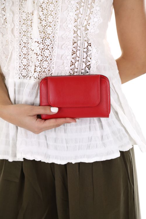 Free Close-up of a woman holding a chic red leather wallet. Perfect for fashion-forward accessory lovers. Stock Photo