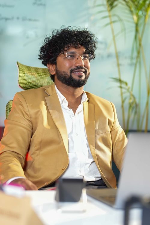Free Confident businessman sitting in an office chair, exemplifying modern professionalism and style. Stock Photo