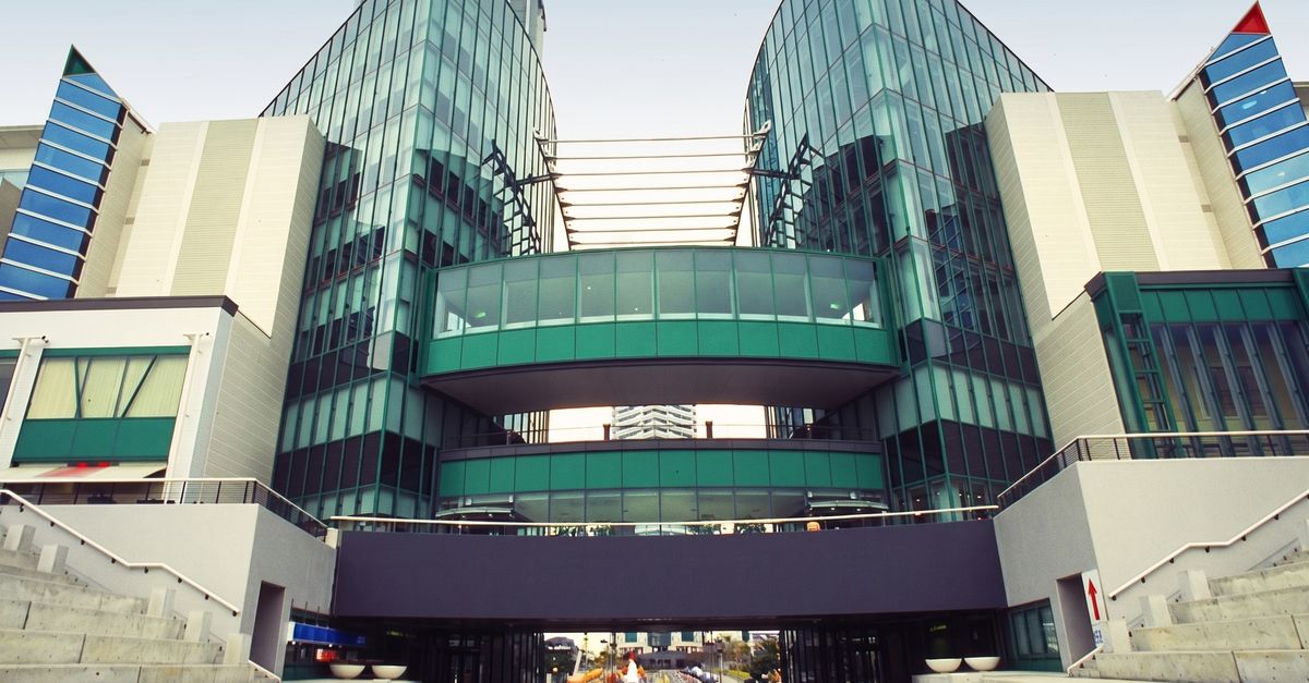 Contemporary building featuring a glass facade and innovative design, perfect for business imagery.