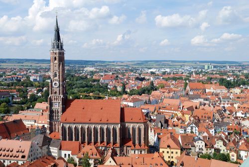 Free Aerial view of St. Martin's Church amidst the vibrant rooftops of Landshut, Germany. Stock Photo