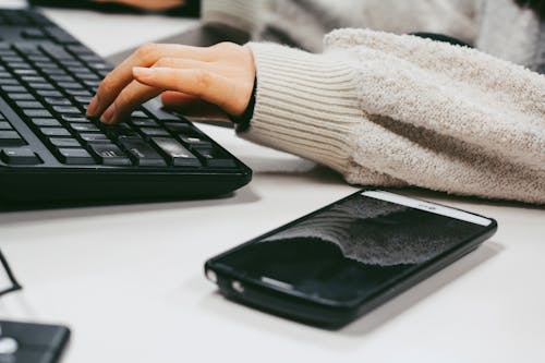 Mobile Phone Beside A Keyboard