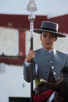 Elegant Spanish horsewoman in Carmona, Andalusia showcasing traditional attire during a cultural event.