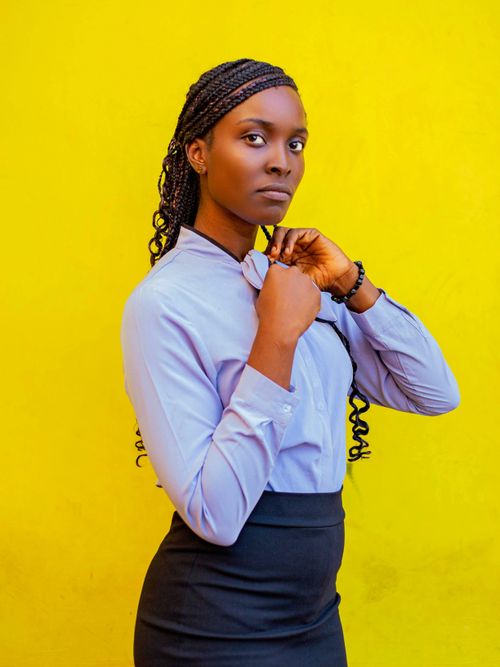Free Stylish woman in fashion portrait wearing pastel outfit with yellow background. Stock Photo