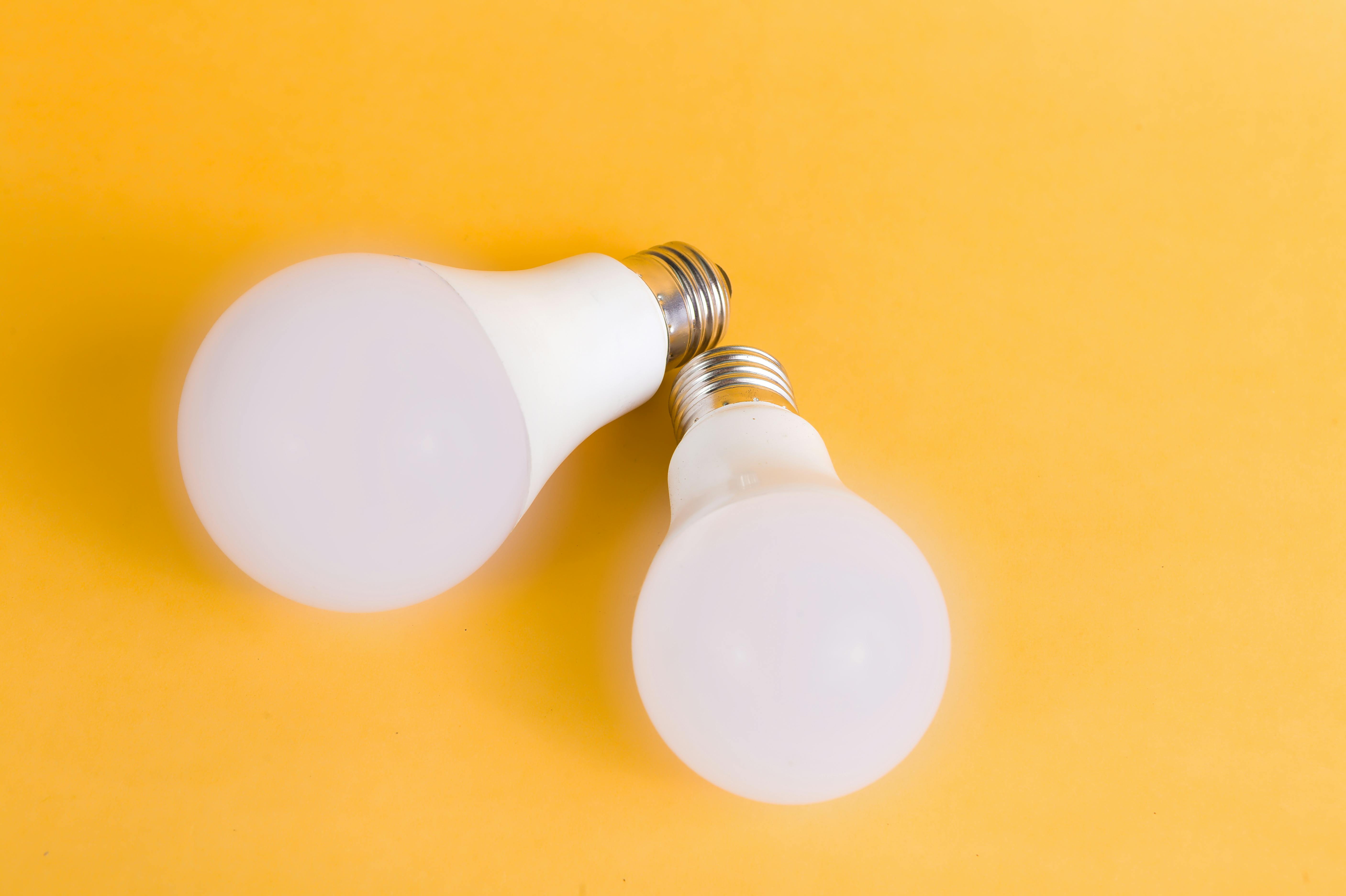 White Light Bulbs On Yellow Surface · Free Stock Photo
