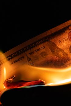 Close-up of a prop bill burning, symbolizing financial loss or risk.