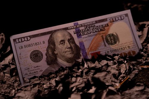 Free Close-up of a realistic fake $100 bill labeled 'For Motion Picture Purposes' on shredded paper. Stock Photo