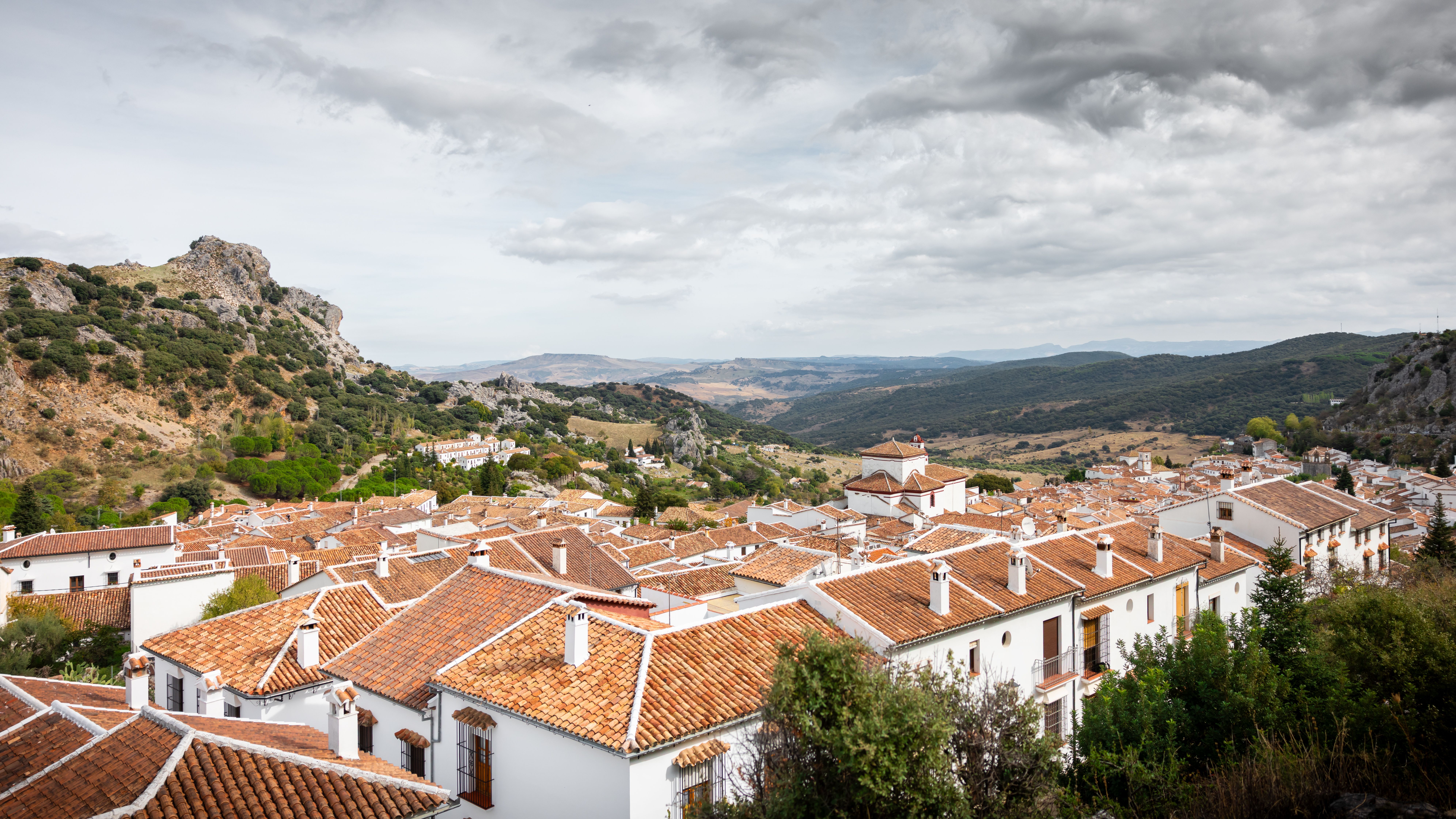 Picturesque Andalucian village with white houses and rolling hills in the background.