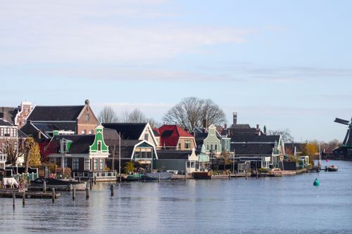Free Picturesque traditional Dutch houses along the waterfront in Zaandam, Netherlands. Stock Photo