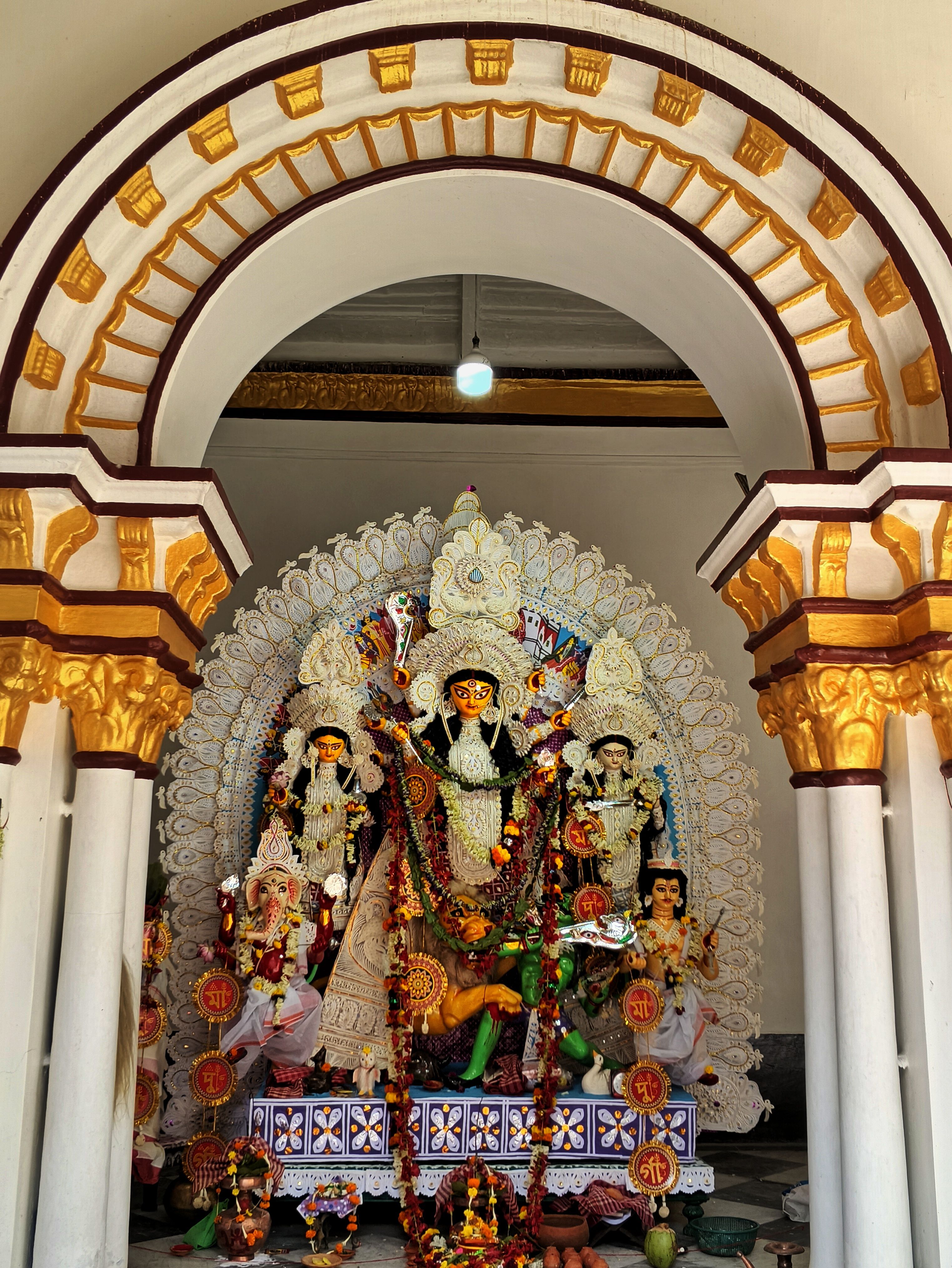 Beautifully decorated Durga Puja idols displayed in a traditional Indian pandal.
