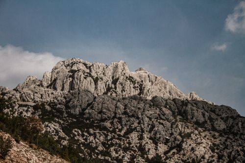 Free Stunning view of a rugged mountain peak under a bright blue sky, perfect for nature enthusiasts. Stock Photo